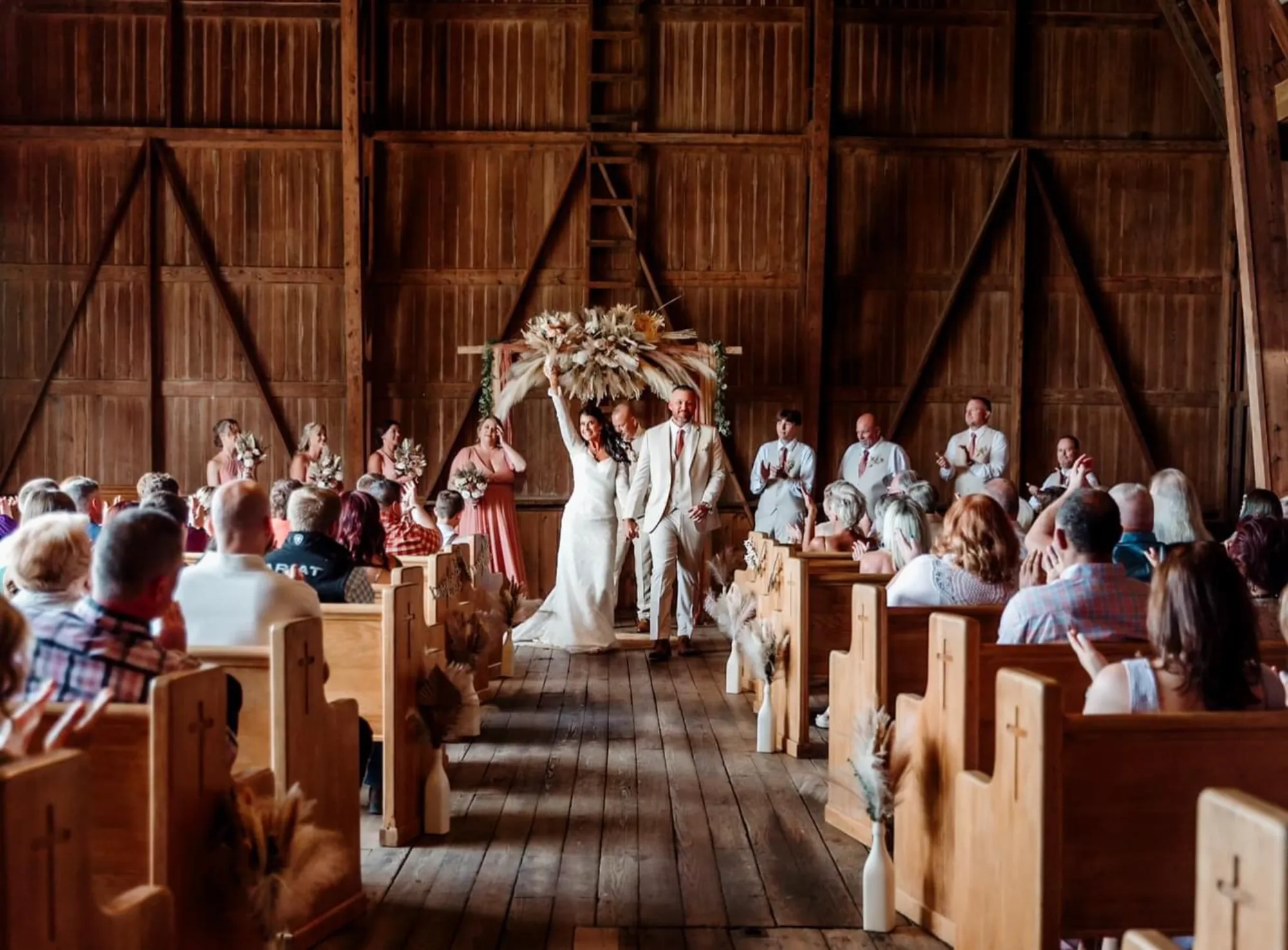 Outdoor ceremony setup on The OT Farms lawn with guests seated facing the barn