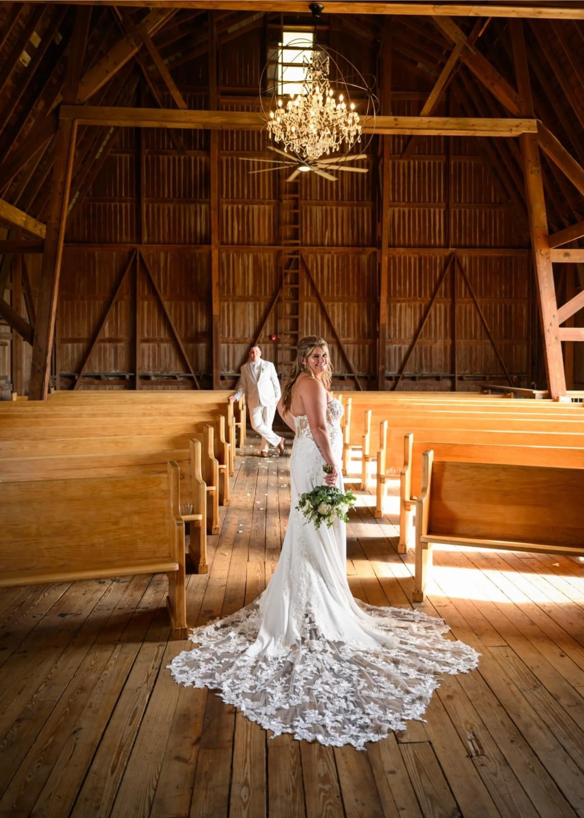 Couple walking through sunlit meadow at The OT Farms